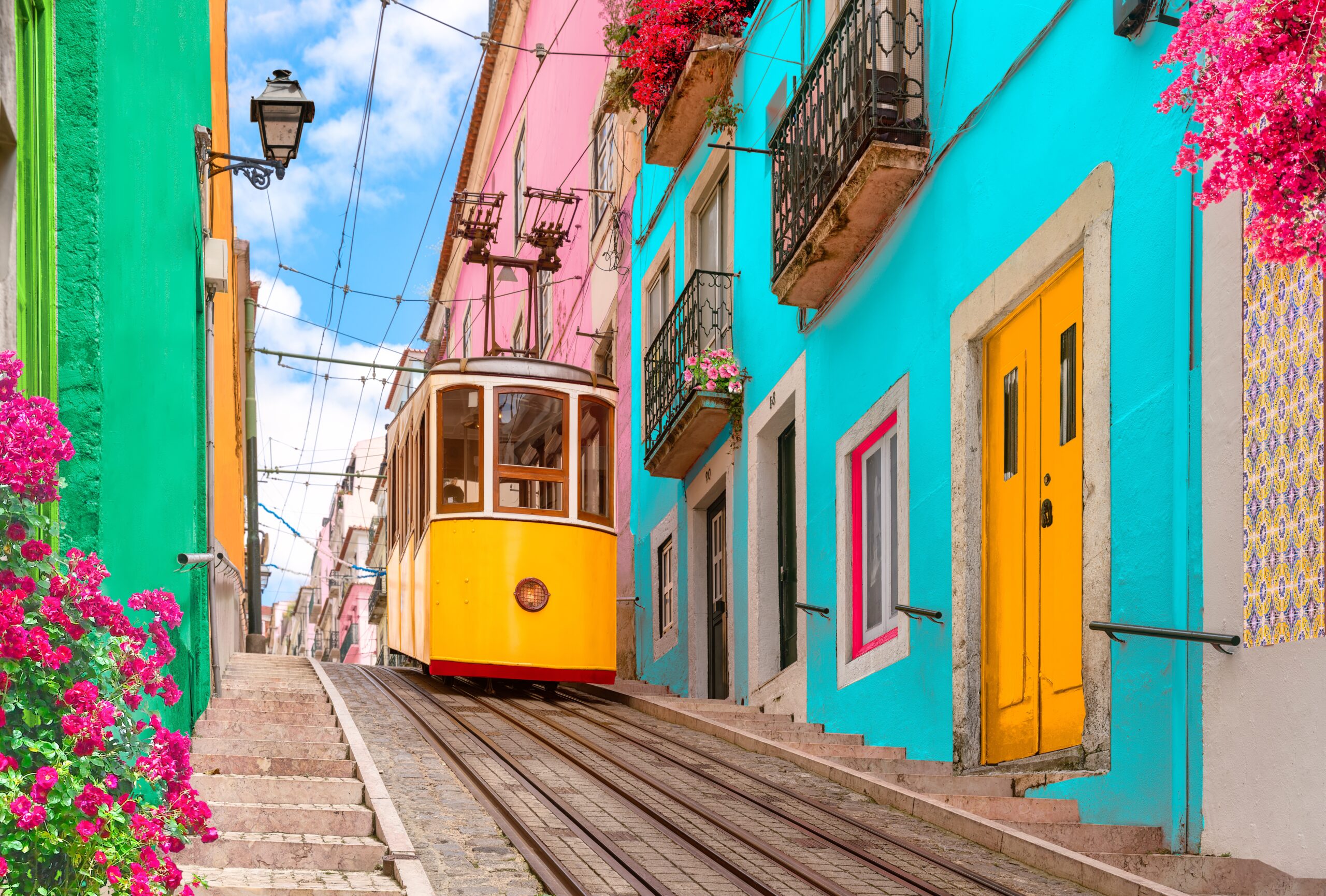 Tram on colourful street in Lisbon