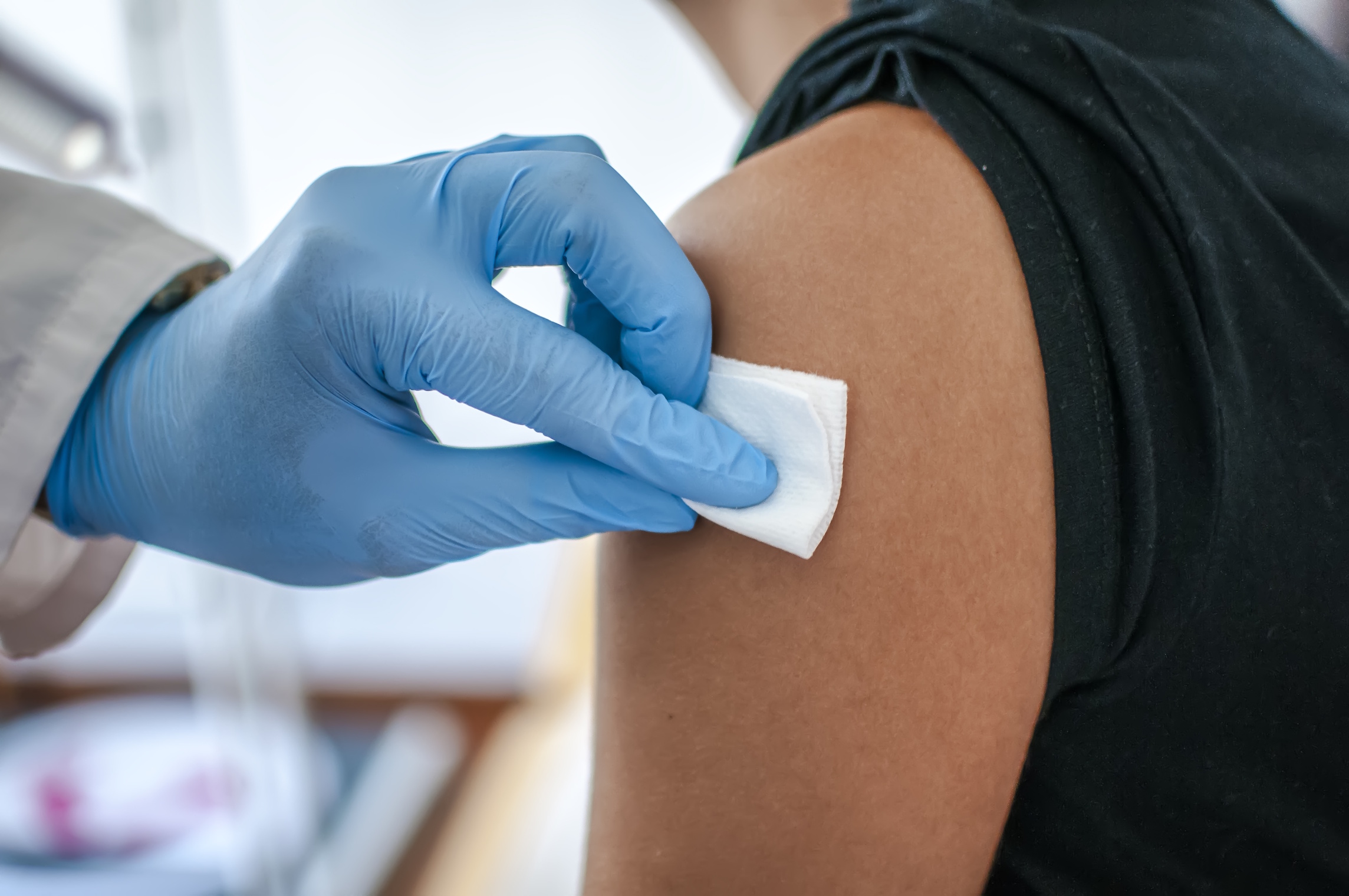 Doctor Disinfects Skin Of Patient Before Vaccination