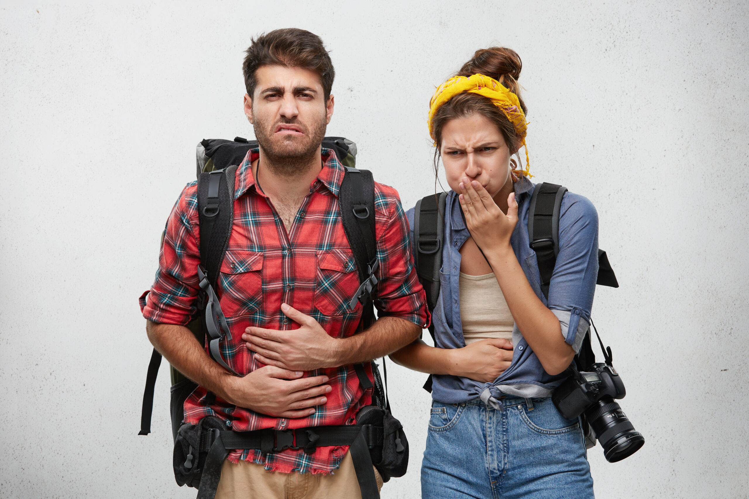 Man and woman looking unwell whilst travelling