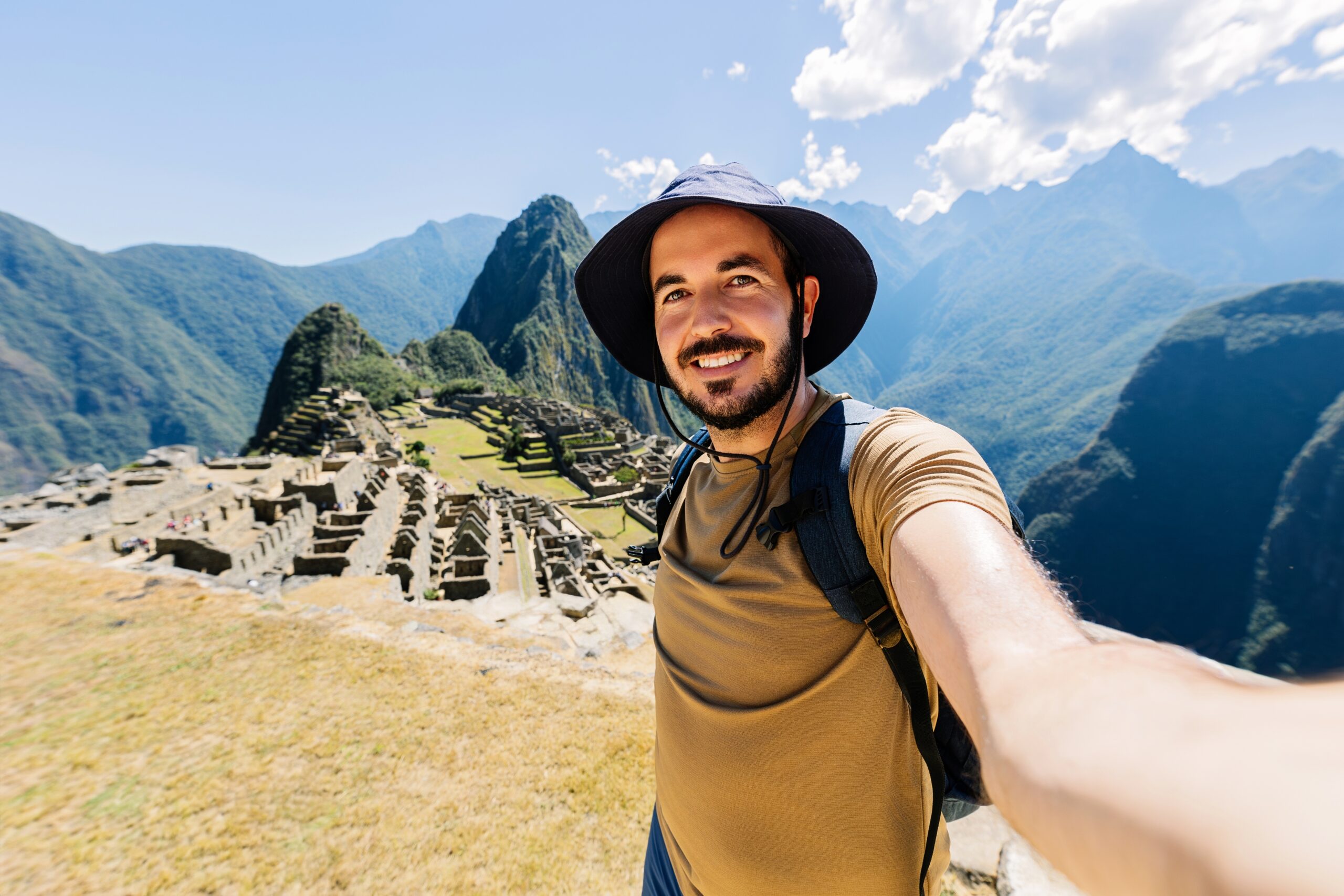 Joyful tourist taking selfie at Machu Picchu.