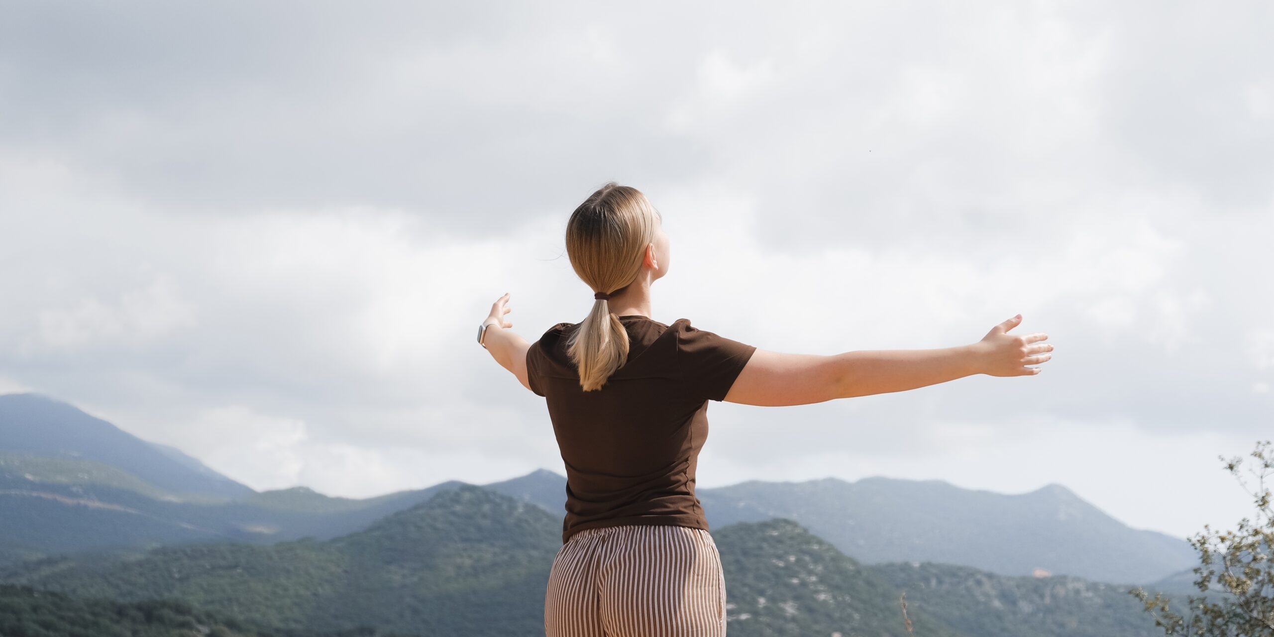 woman mediating on mountain